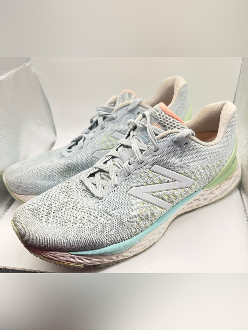 New Balance women's light gray athletic sneakers with mint and coral accents
